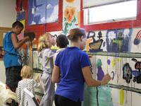 What fun! Children paint a mural inside one of the buildings at St. Lucy's Roman Catholic Church