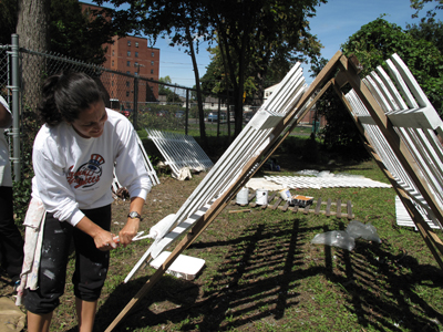 Fence painting a garden at St. Lucy's.